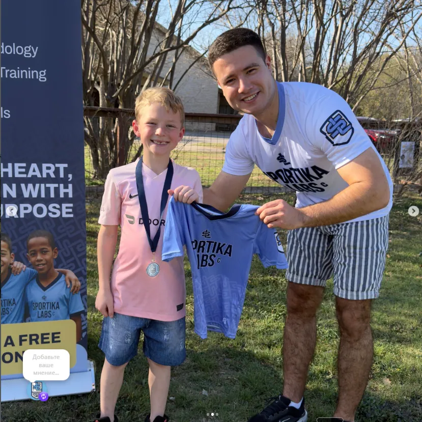 A young player at the Austin community fair holding a Sportika Labs jersey